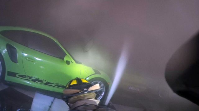 Helmet-cam: Firefighters battle blaze in garage of classic Porsches