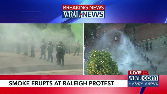 Smoke billows in front of Governor's mansion as tensions rise between protesters, police