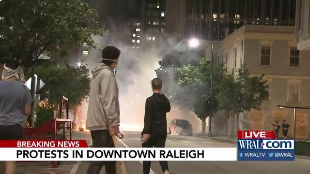 Fire builds and fireworks thrown in downtown Raleigh