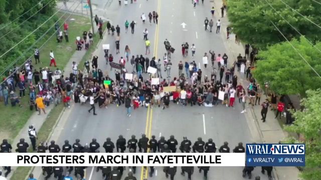 Caught on cam: Fayetteville officers kneel in front of protesters