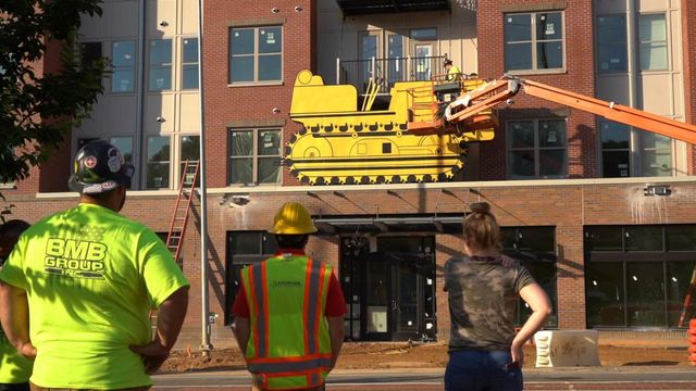 Iconic yellow tractor sign returned to Hillsborough Street