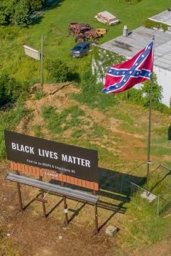 Black Lives Matter sign and Confederate flag