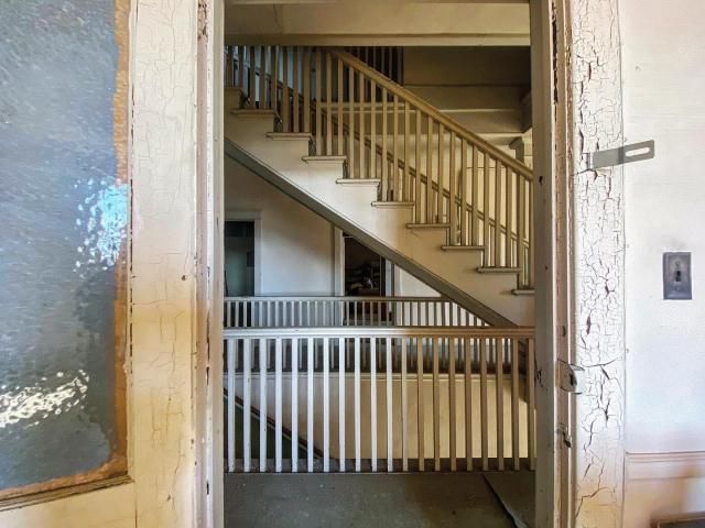 The stairwell to the meeting chambers as seen through an office door.