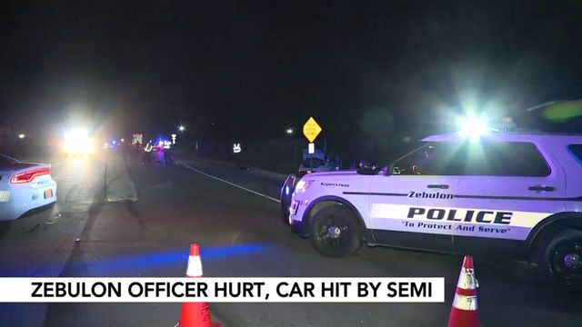 Police officer's car totaled by semi-trailer truck