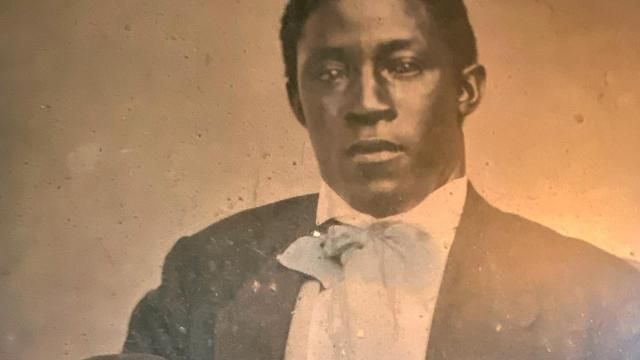 A man poses for a photograph taken in the 1800s.