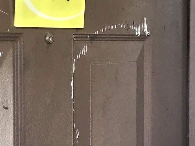 Chainsaw damage to hotel room door
