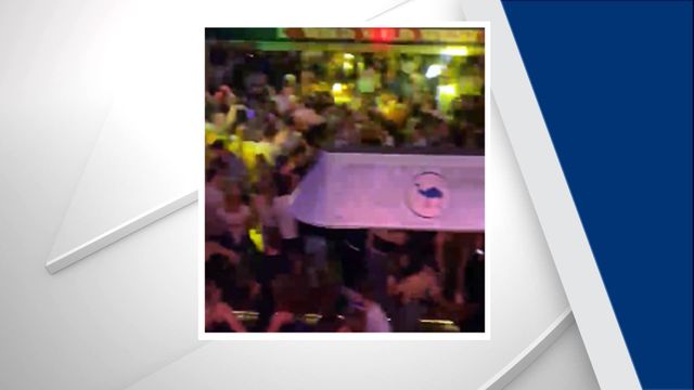 Raw: Unmasked crowd packs Durham bar