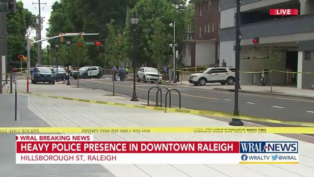 Woman found dead along busy Raleigh road