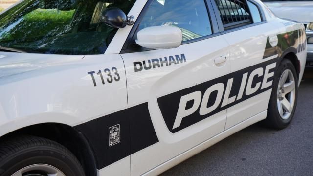A Durham Police car is parked outside of the Durham Police Headquarters on East Main Street. 