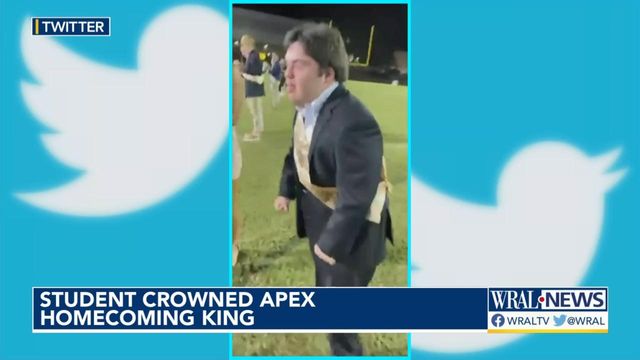 Apex High student celebrates his Homecoming King crowning with a skip