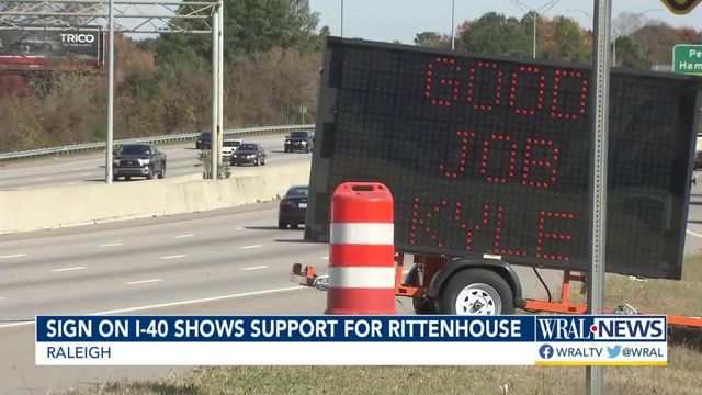 Man uses large traffic sign to display political messages along I-40