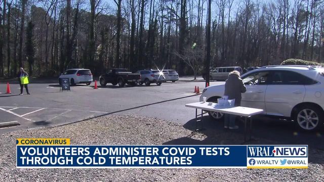 Volunteers administer COVID-19 tests through cold temperatures