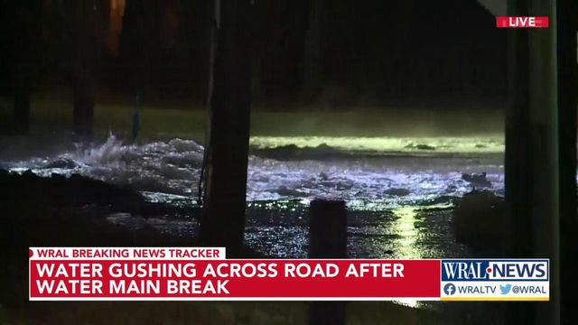 Water gushes down Alston Avenue in Durham