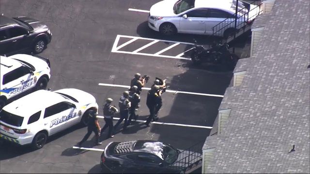 Heavy police presence with tactical gear near Garner High School
