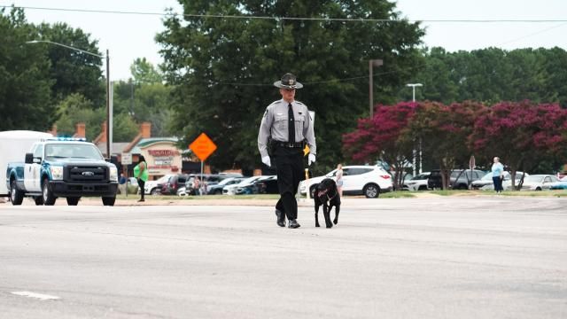 Wake County Deputy Ned Byrd's K-9, Sasha, walks to his funeral