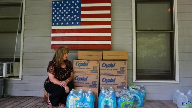 Woman with bottled water at her home in Hope Mills, NC