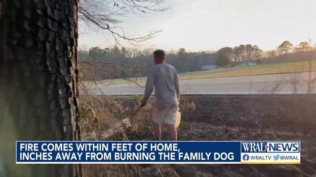 Fire comes within feet of home, inches away from burning the family dog