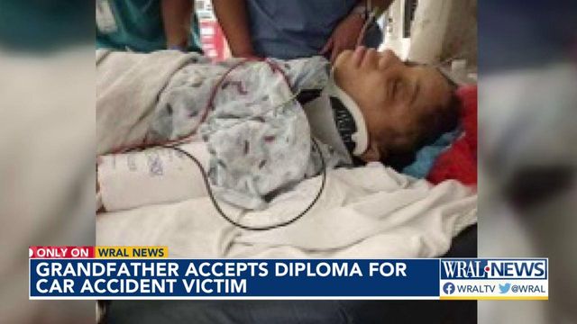 Grandfather accepts diploma for car accident victim