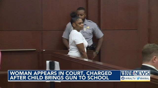 Woman appears in court charged after child brings gun to school 