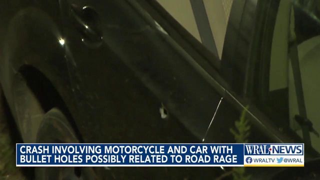Crash involving motorcycle and car with bullet holes possibly related to road rage