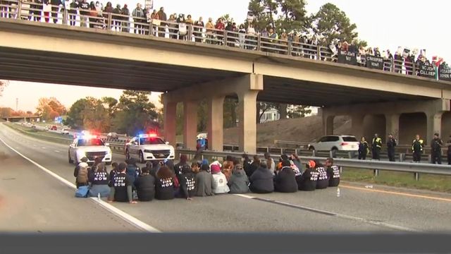 Anti-war protesters block rush hour traffic on NC 147 in Durham 