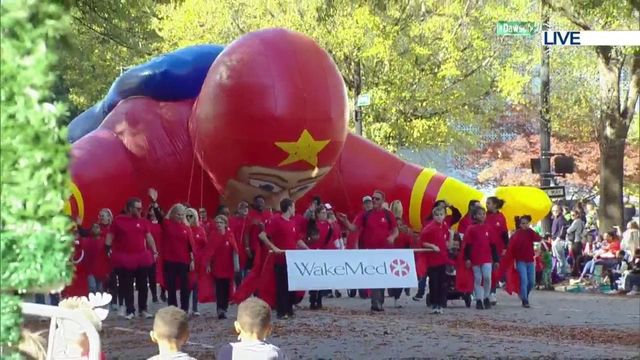 Building-sized superhero float flies through Raleigh Christmas Parade 