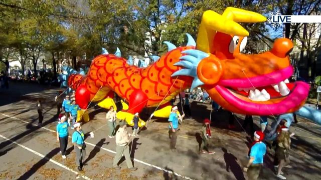 The Chinese Lantern Festival walks in the parade with a dragon float