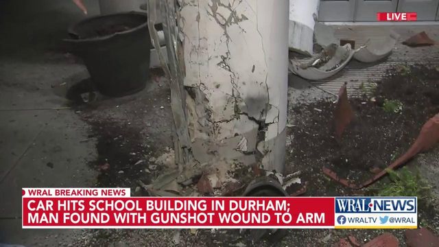 Car hits school building in Durham, man shot in arm