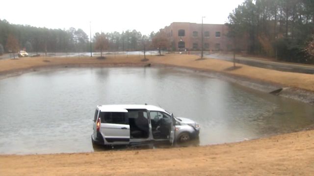 Live: Vehicle partially submerged in Apex pond 