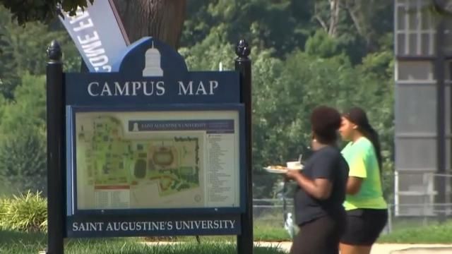 Students walk along Saint Augustine's University campus.