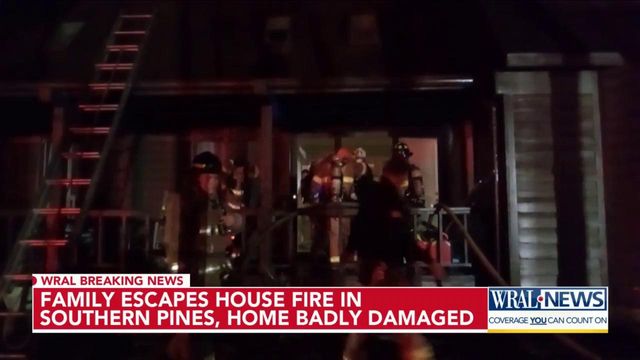 Two-story house catches fire, adults and child escape