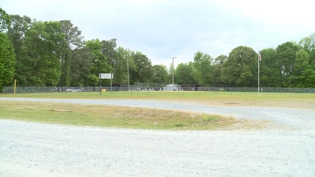 Authorities said they found a man dead from an apparent self-inflicted gunshot wound inside a car at the school's athletic field.