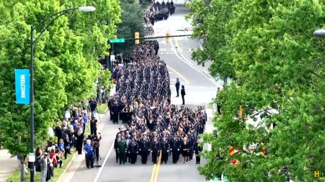 Hundreds of officers march in processional for fallen officer who died in Charlotte.