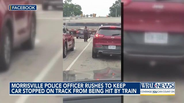 VIDEO: NC police officer helps driver off tracks seconds before train speeds past