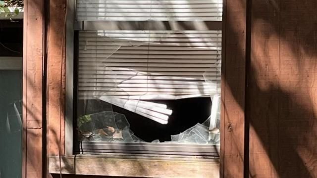 A shattered window at a home that was shot at in a drive-by shooting in a Fayetteville neighborhood.