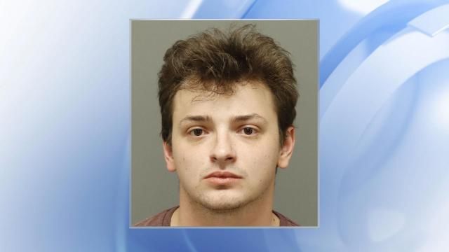 Zachary Olson, 24, was charged Monday with felony carrying a gun on educational property and misdemeanor carrying a concealed weapon.