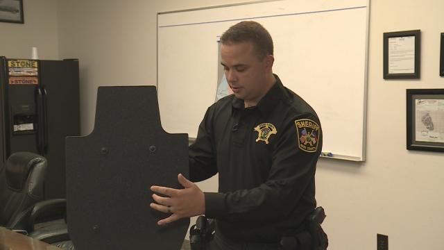A Nash County School Resource Officer demonstrates how a ballistic shield is used.