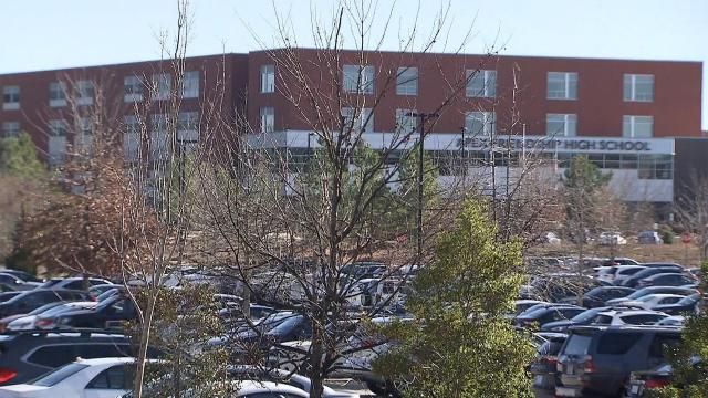 A file photo of cars parked outside of Apex Friendship High School.