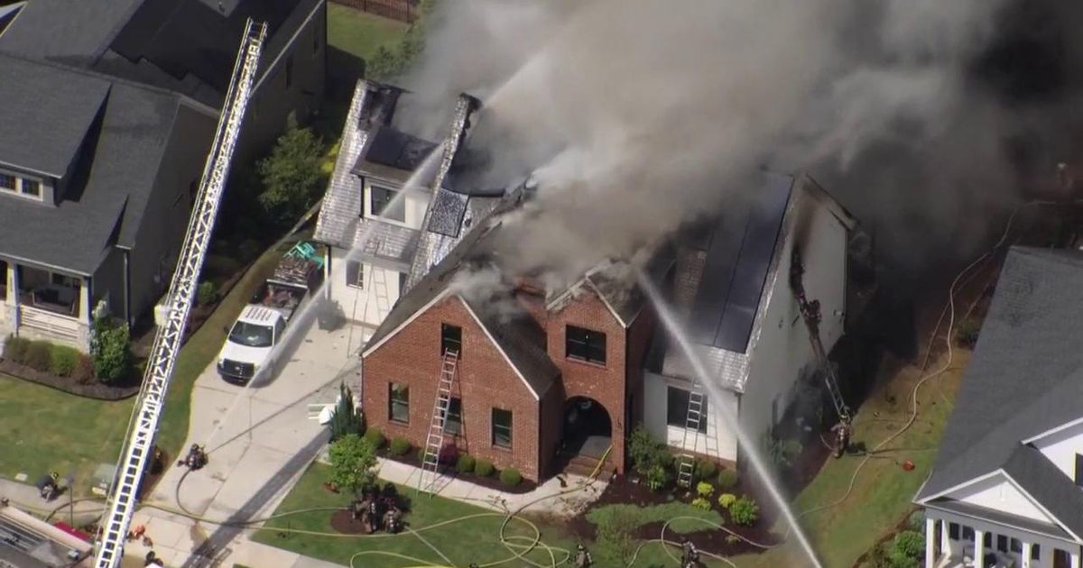 Firefighters work to put out Durham house fire