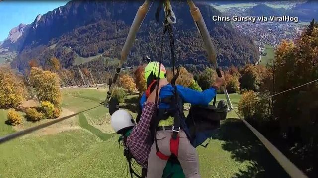 Hang glider holds on after instructor fails to strap him in