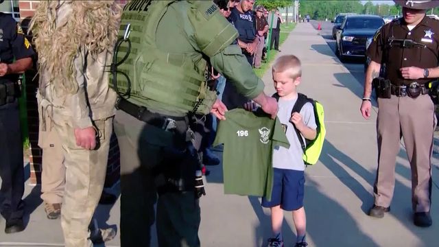 Raw: More than 50 officers escort five year-old to school