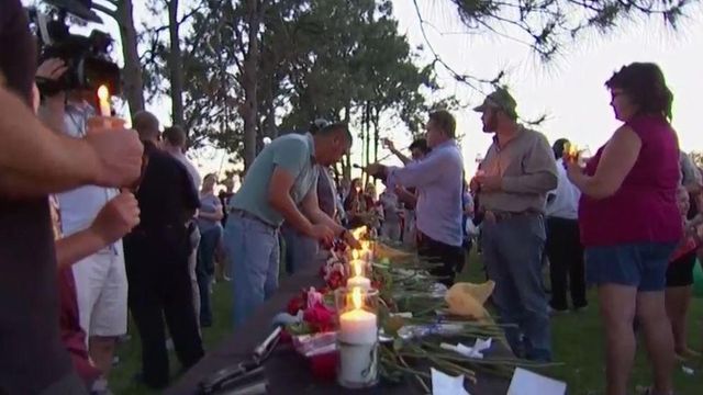 School shooting suspect makes court appearance; vigil honors victims