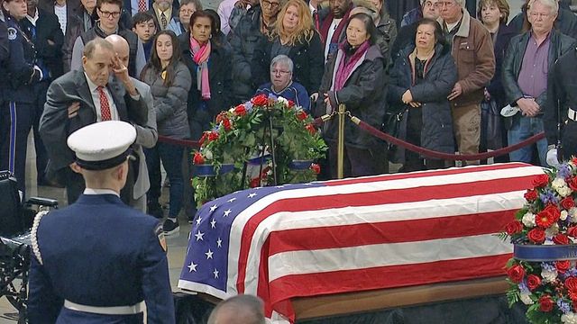 2018: Bob Dole salutes Bush's casket