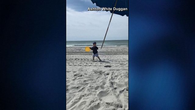 Close call: Toddler nearly impaled by flying beach umbrella