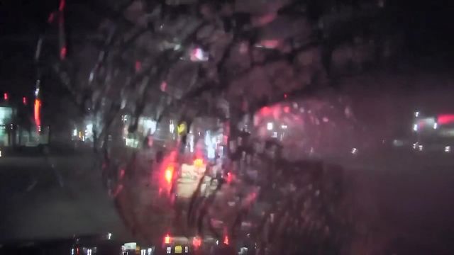 Street sign smashes into police car's windshield