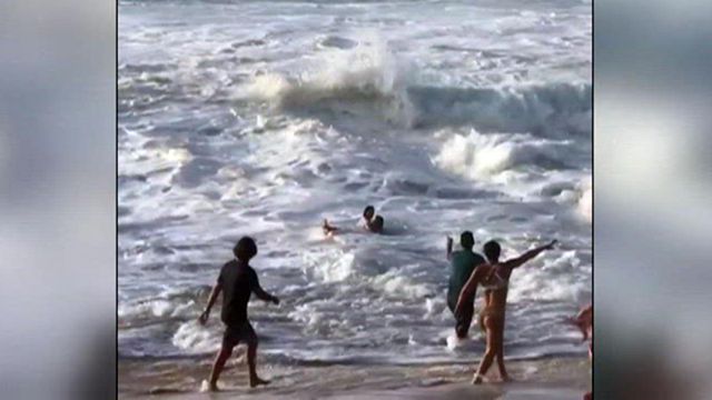 Caught on camera: Vacationing surfer pulls woman from rough Hawaii waves
