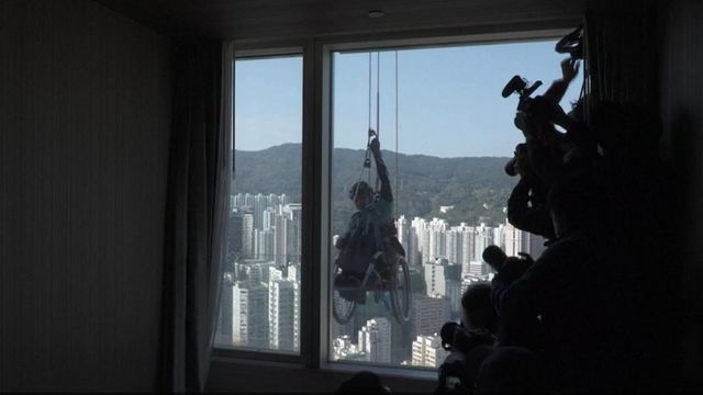 Man climbs skyscraper in wheelchair 