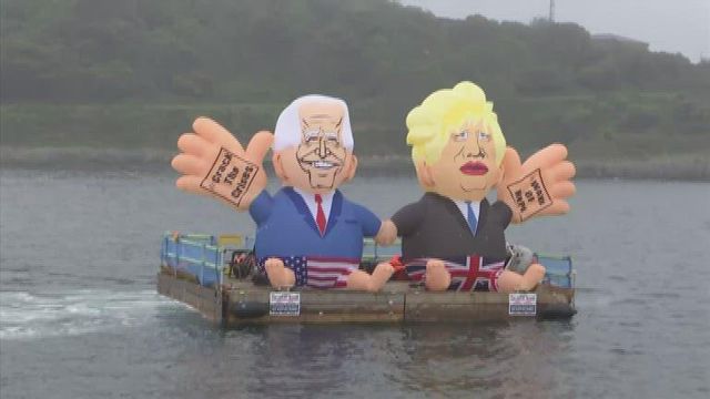 G7 protest includes barge carrying inflatable figures of Biden, Johnson