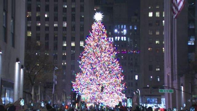 Crowd celebrates lighting of Rockefeller Plaza Christmas tree
