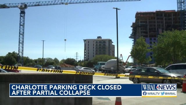 Cement truck partially falls through parking deck